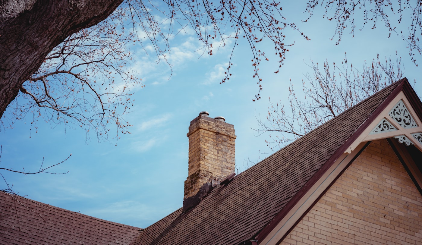 Repointed brick chimney with new crown and stainless steel cap