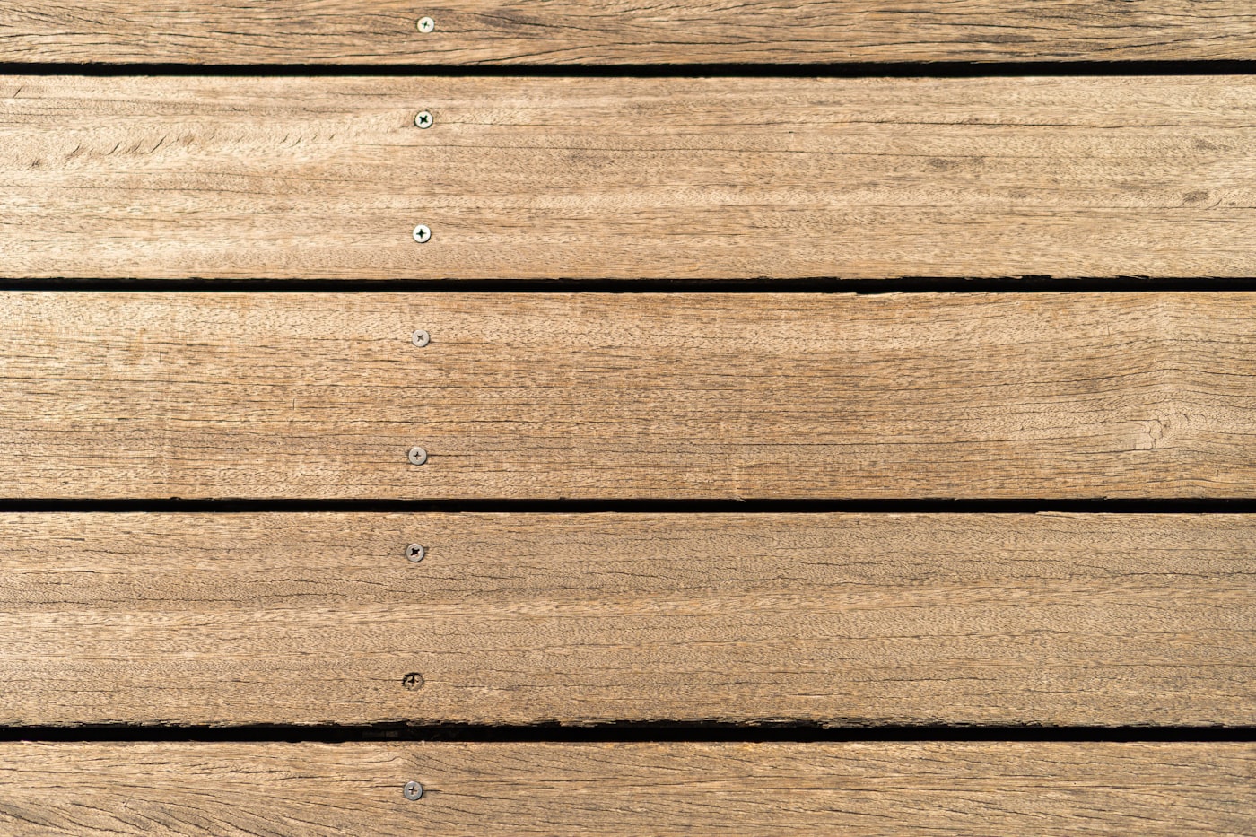 Custom composite deck with railings attached to the back of a Long Island home