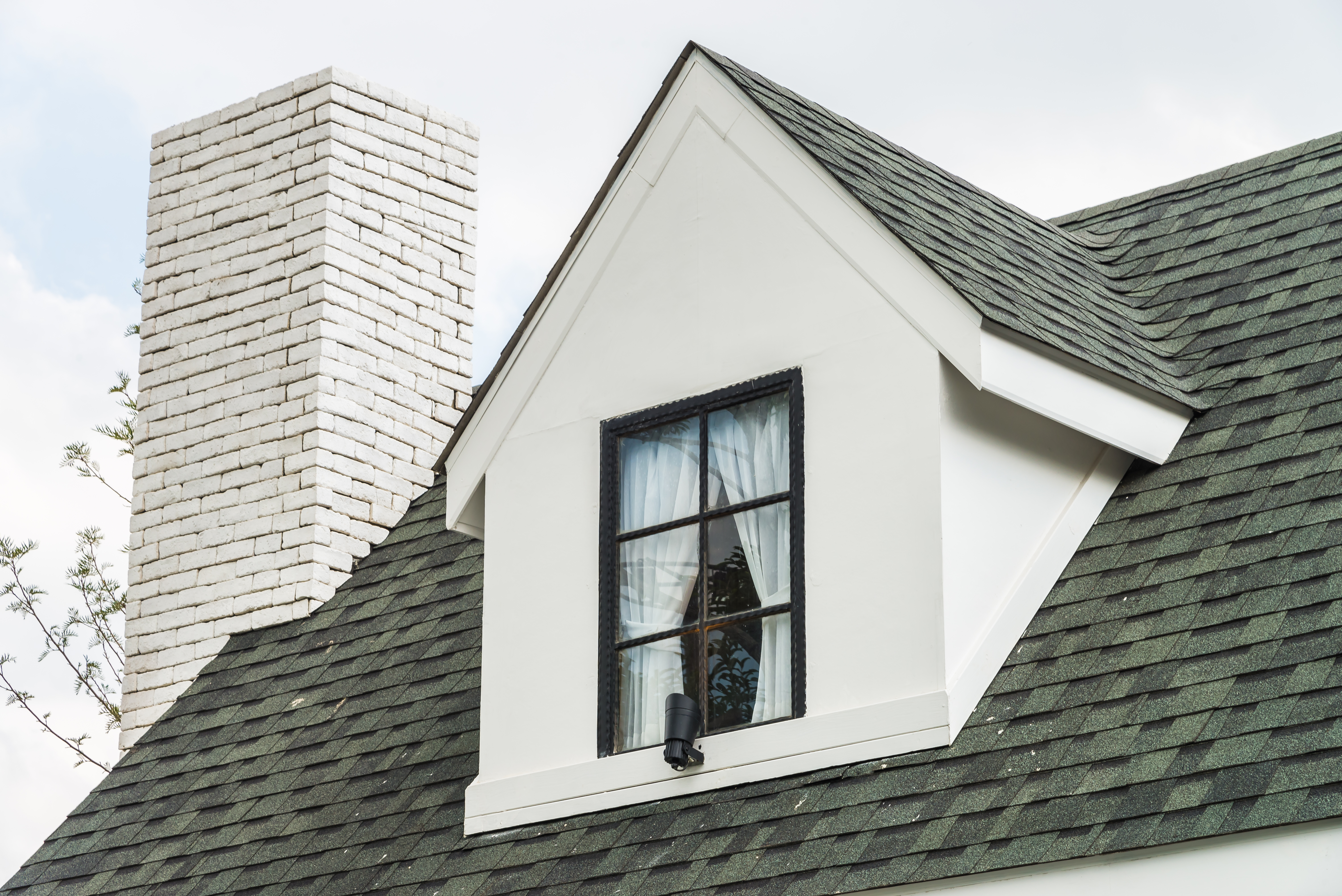 Newly installed asphalt shingle roof on a suburban Long Island house