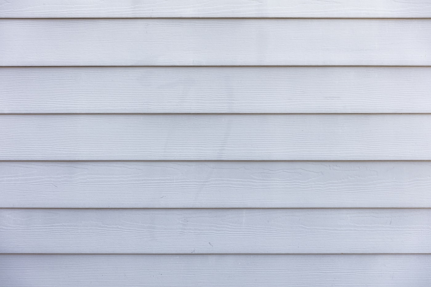 After: new fiber cement siding with crisp trim and new seamless gutters
