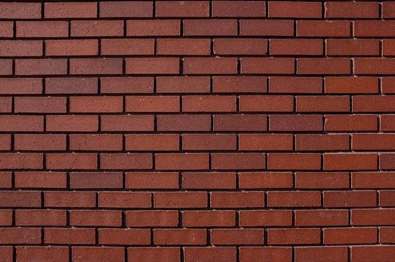 Damaged bricks being replaced in a wall