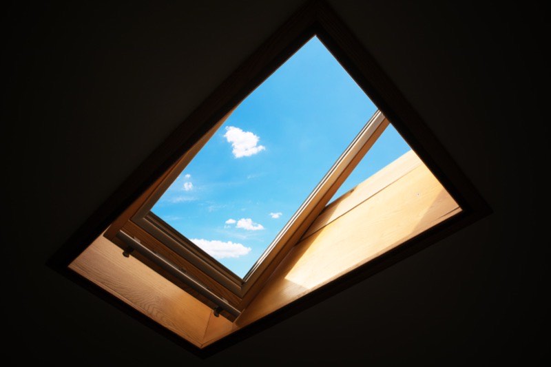 Skylight set into a sloped shingle roof