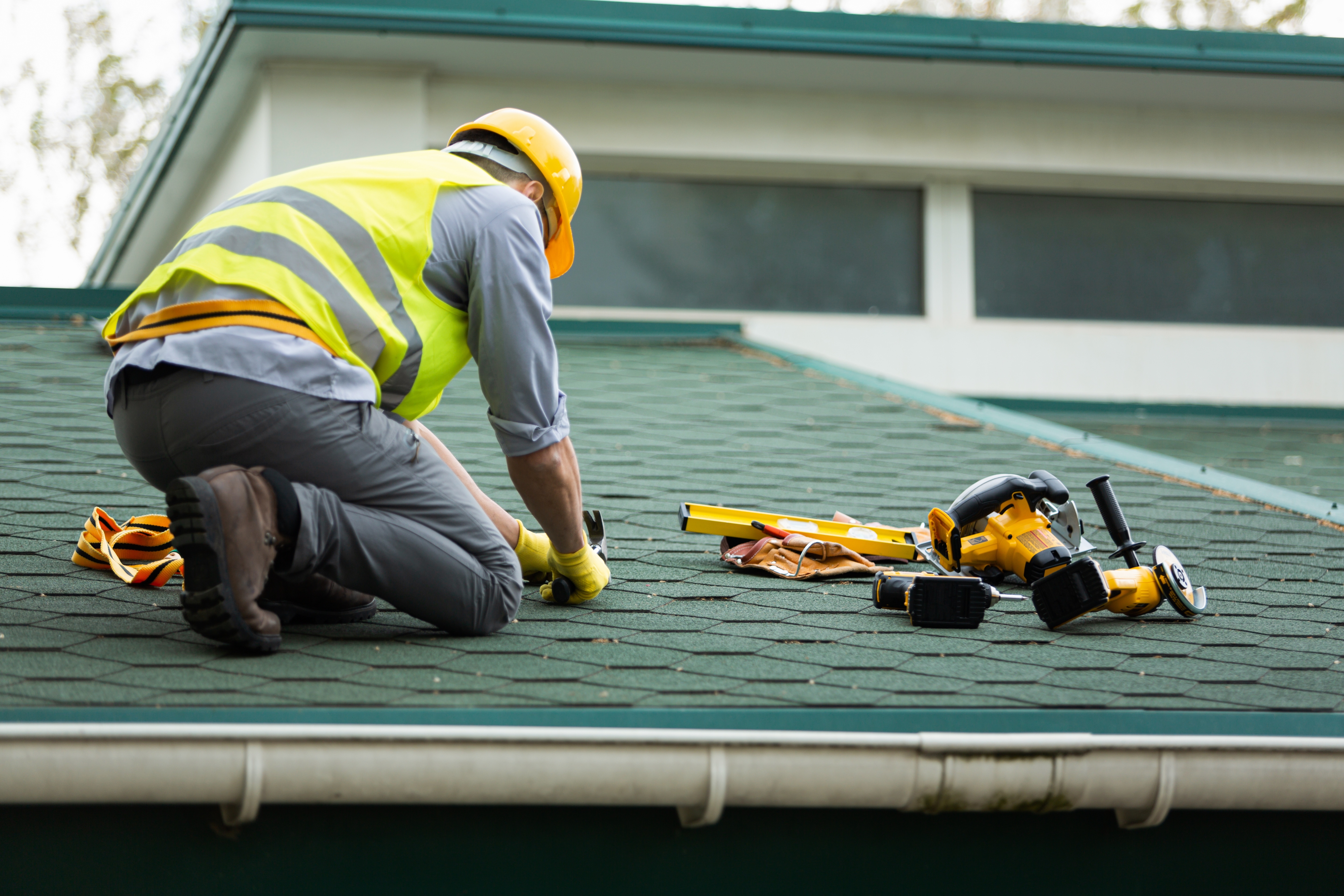 Cape Construction Co roofer securing underlayment before shingle installation